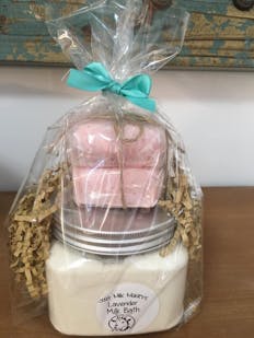goat milk bath and pink soap packaged in cellophane gift wrapping